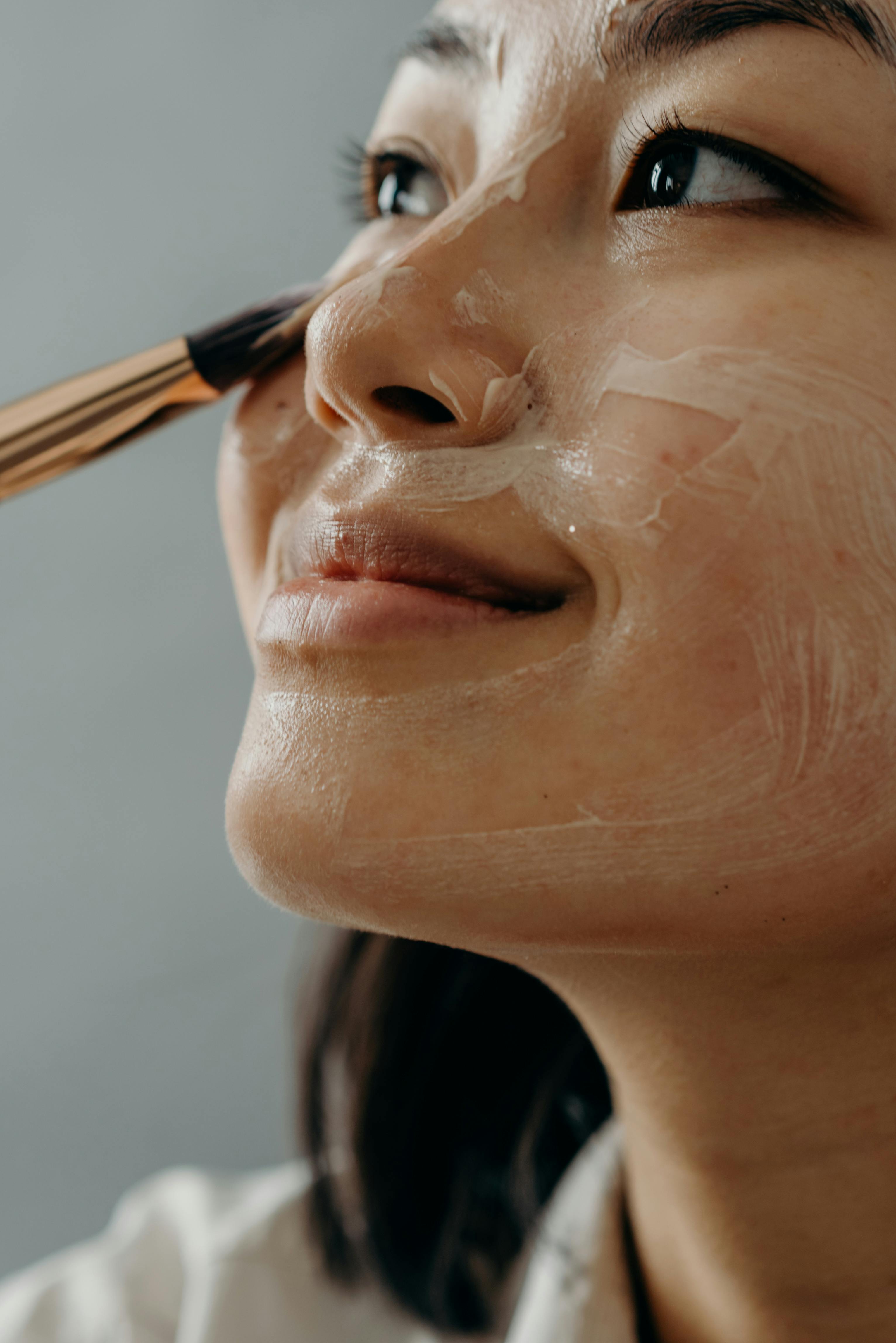 Femme qui s'applique de la skincare coréenne sur le visage en format paysage